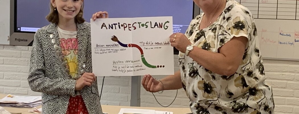 Kinderburgemeester Myrthe reikt anti-pest poster uit aan Daltonschool de Windroos